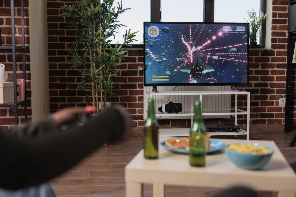 young woman having fun with shooting video games console playing game competition with group friends house party with alcoholic drinks people enjoying gathering with shooter strategy
